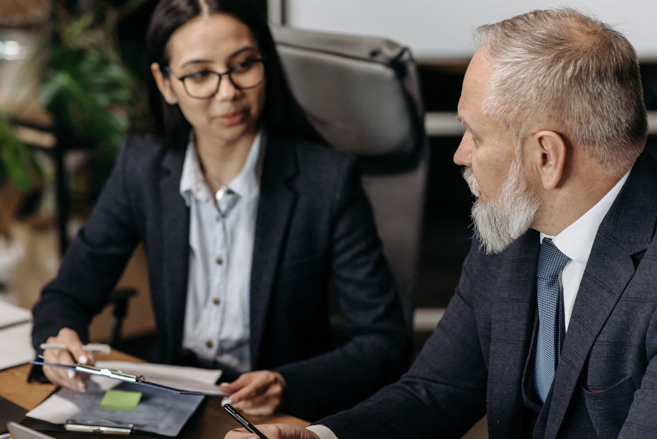 HR professionals in a formal office meeting discussing a workplace matter